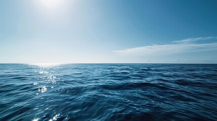 Obraz premium Calm Blue Ocean Sunrise at Flat Camera Angle: Serene Horizons, Soft Golden Rays, and Minimalist Coastal Aesthetics in Dawn Photography – Smooth Water Textures and Pastel Skies