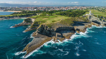 Aerial view of the Cape Mayor lighthouse on the rocky coast in Santander, Spain