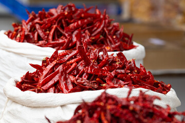 Red chilli pepper spices for sale on a spice market in Mumbai, India, fresh ingredients for cooking...