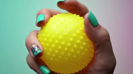 Close-Up of Hand Squishing a Yellow Stress Ball for Relief - Powered by Adobe