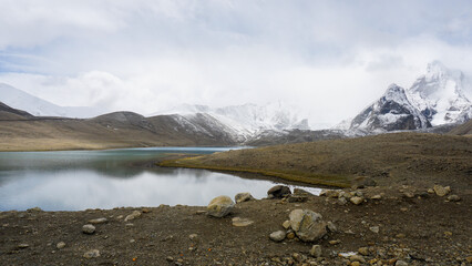 Mountain landscape with lake and snow in Gurudongmar Lake, Sikkim, India