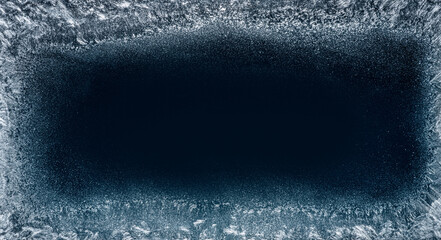Frost patterns on frozen winter window as a symbol of Christmas wonder. Christmas or New year background.