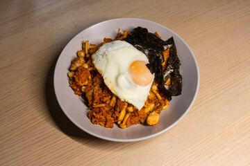A plate of kimchi fried rice with fried egg.