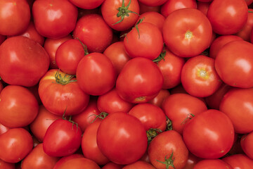 Fresh red cherry tomatoes stacked on a stall at the Athens farmers market - organic background