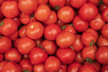 Fresh red cherry tomatoes stacked on a stall at the Athens farmers market - organic background