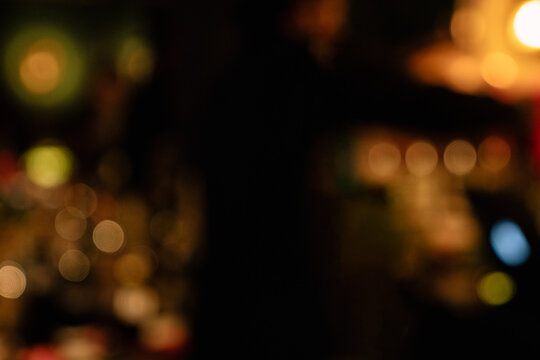 Warm Golden Bokeh Lights in a Dark Ambient Restaurant Scene