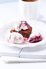 Strawberry ice cream with chocolate and cherry syrup on chocolate brownie. Selective focus.	