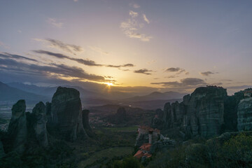 Landscape of rock formations of Meteora with Roussanou and Agios Nikolaos Monasteries on top of rocks during sunset, Kalambaka, Thessaly, Greece