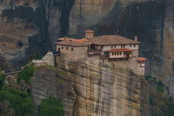 Detail view of landscape of the famous rock formations of Meteora with Roussanou Monastery on top of the rocks, Kalambaka, Thessaly, Greece