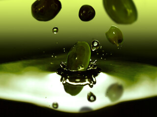 Olives falling into olive oil