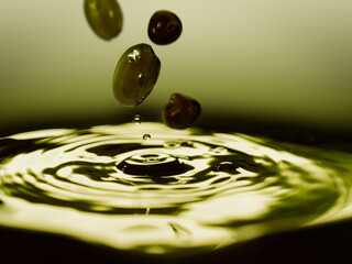 Olives falling into olive oil