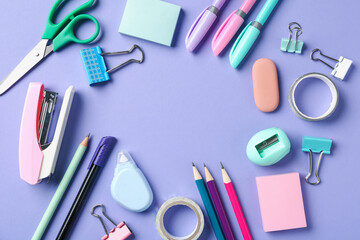 Pens and other stationery on violet background, flat lay. Space for text