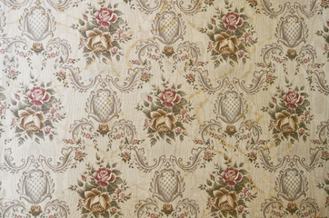 Old wallpaper on the wall. Old wallpaper for texture or background.