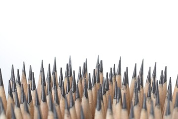 Many graphite pencils on white background, closeup