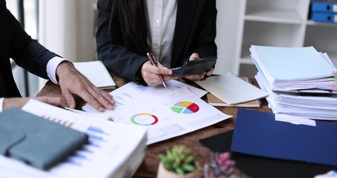 Accounting record with analyze financial data calculator in meeting office, Accounting company charts and graphs banner, double exposure successful business finance and taxation planning concept. - Powered by Adobe