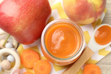 Baby food. Tasty puree in jar, ingredients and teether on table, flat lay