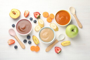 Baby food. Tasty puree in bowls and different ingredients on white wooden table, flat lay
