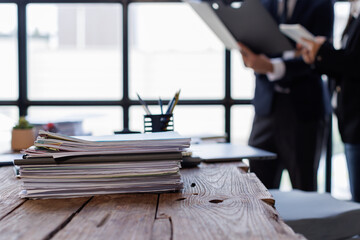 Business Documents,  business people checking and charts to analyze market data, balance sheet, account, net profit to plan new sales strategies to increase production capacity.	
