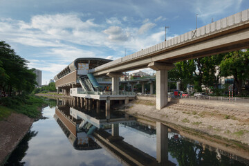 Electric train station by the river in Hanoi, Vietnam showcasing modern transport architecture and vibrant city life