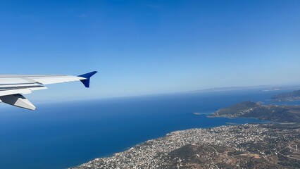 an airplane wing and a magnificent view of the ocean