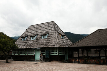 Traditional wooden restaurant in village Drvengrad, featuring mint-colored windows and wooden shingles. Mokra gora, Serbia - 15 May 2025.