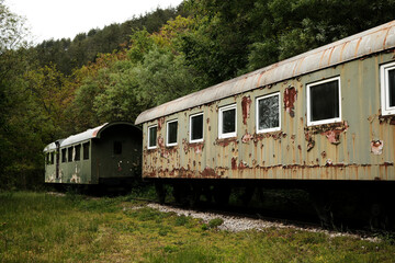 Rusty abandoned railway cars on tracks in the forest near Mokra Gora, Serbia.