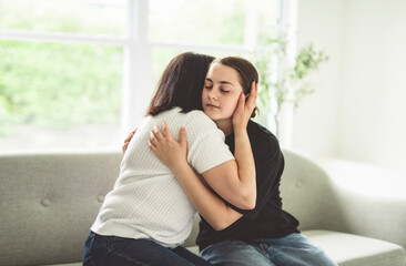 mother comforting depressed sad teen girl, hugging daughter with love