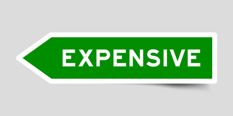 Green color arrow shape sticker label with word expensive on gray background