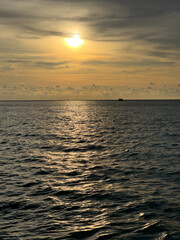 Golden sunlight reflecting on calm ocean surface