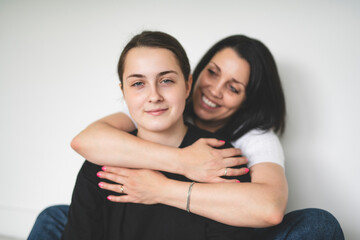 mother with teen girl, sit on the floor