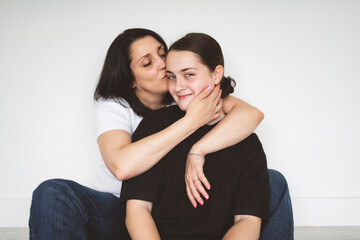 mother with teen girl, sit on the floor