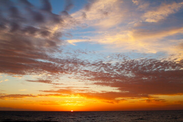 Sunset sky in orange and blue colours at the sea (Tenerife, Canary Islands, Spain)