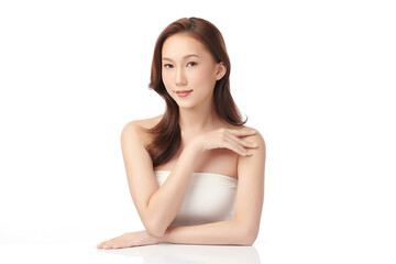 Fototapeta premium A beautiful young Asian woman with clean, fresh skin against a white background. Skincare, facial treatment, cosmetology, beauty, and spa. An elegant portrait of an Asian woman.