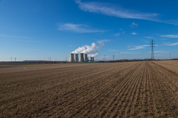 Dukovany Nuclear Power Plant in the Czech Republic, Europe. Smoke cooling towers. There are clouds in the sky. In the background the nature of the Highlands.