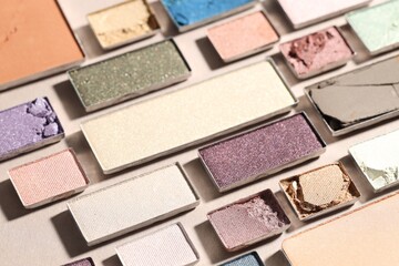 Beautiful eyeshadow refill pans on beige background, closeup