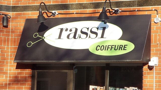Ottawa, ON, Canada-June 05,2025: A sign for a business named "Rassi COIFFURE"at 2 Beechwood Avenue. 
