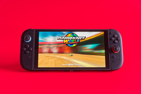 Fukuoka, Japan - june 7, 2025 : nintendo switch 2 game console running 2025 famous game Mario Kart world isolated on red background