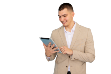 Young professional man in a suit and white shirt, smiling while using a tablet against a transparent background