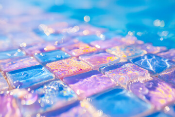 Sunlit blue glass tile mosaic wall with reflective surfaces