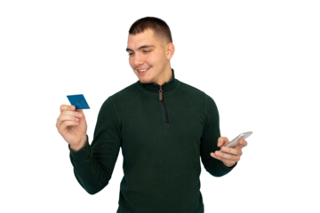 Smiling male processing digital payment, gripping credit card and using smartphone, standing against transparent backdrop