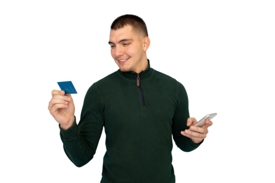 Smiling male processing digital payment, gripping credit card and using smartphone, standing against transparent backdrop - Powered by Adobe