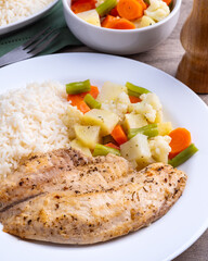 Grilled tilapia or saint peter with rice and vegetables
