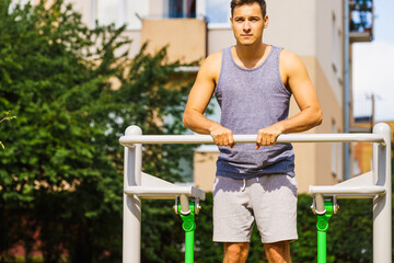 Man doing legs exercises in outdoor gym
