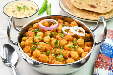 Serving chana masala dish with roti and rice.