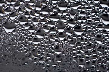 background, unusual, abstract. drops of morning dew, condensation on the glass. wet glass. water drops close-up. beautiful background for text. Spray cool water on the glas, condensate