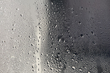 background, unusual, abstract. drops of morning dew, condensation on the glass. wet glass. water drops close-up. beautiful background for text. Spray cool water on the glas, condensate