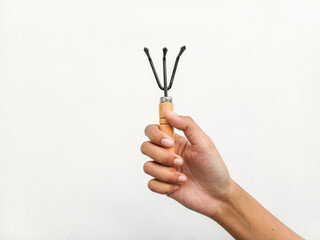 woman's hands holding a set of gardening tools on a white background. eco concept, Space for your text