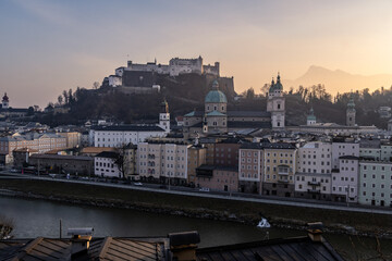 Salzburg, Austria: Sunset over Salzburg medieval city center skylien with the forrtress and the Salzbur Cathedral along the Salzbach river.