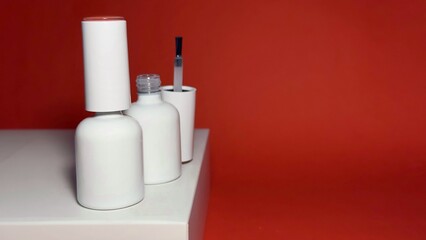 White nail polish jars lined up on a shelf with a brush
