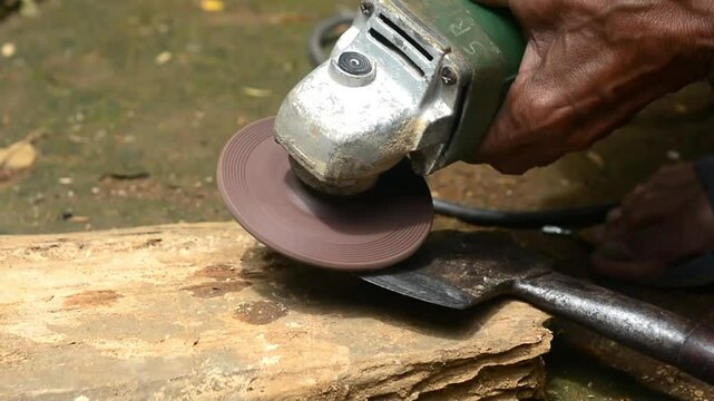 Isolated close up of chef knife sharpening, honing and stropping process by  a skilled craftsman. Vintage old school craftsman at work in grange shop showing true professional skills.